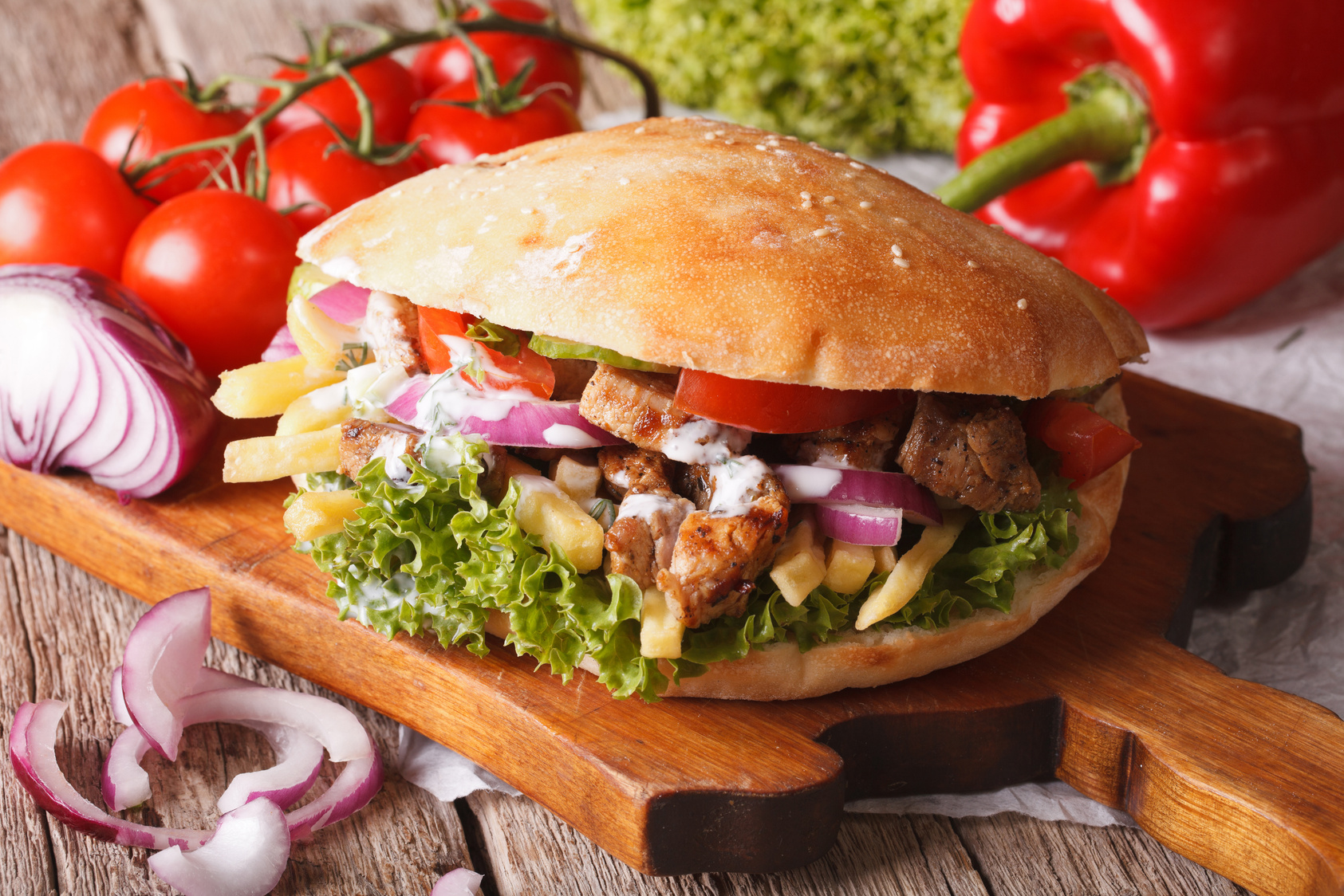 Doner kebab with meat, vegetables and french fries closeup. hori